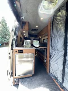 and open screened doors to the outside.|Inside this modern RV rental — photo 11