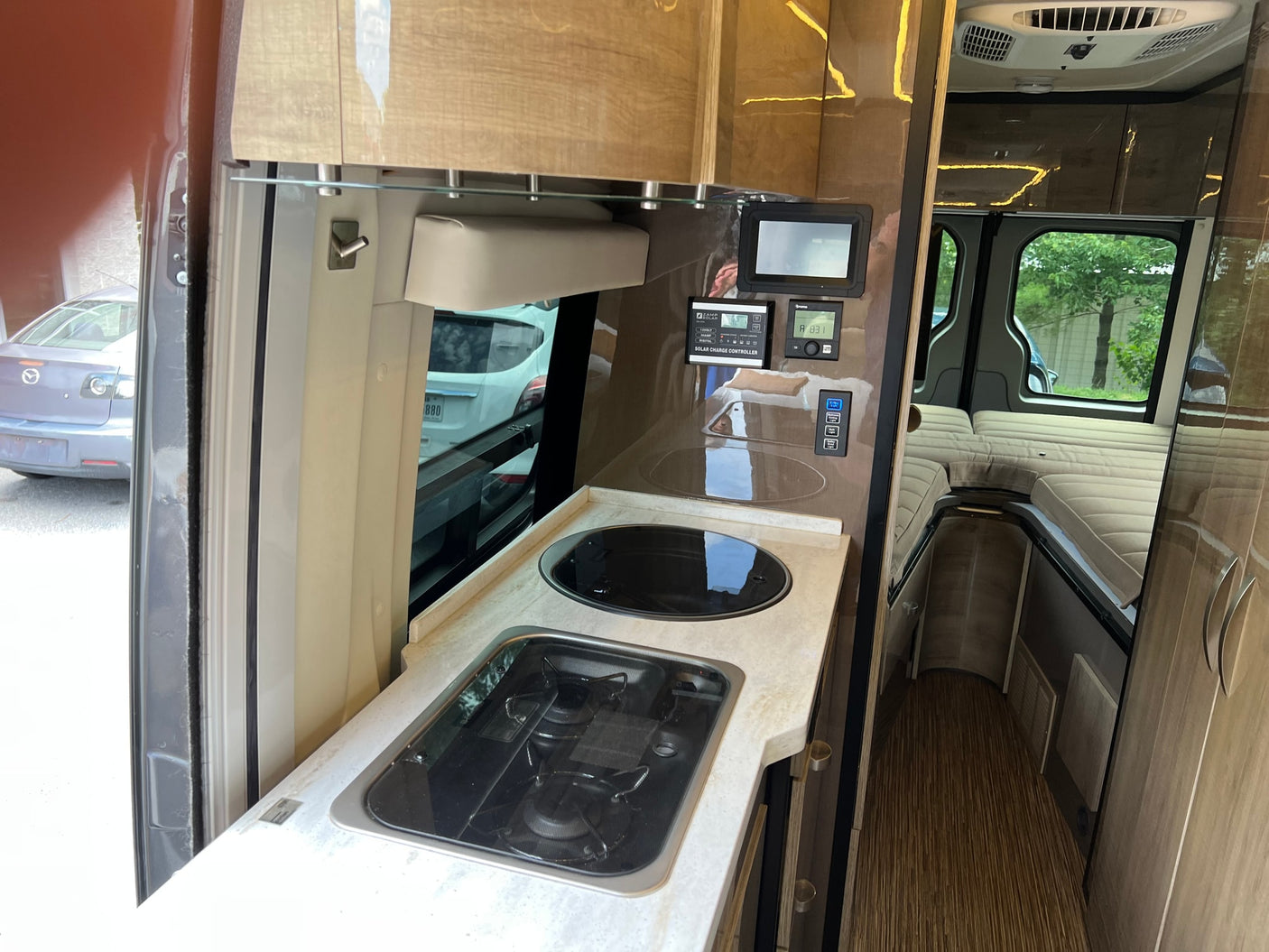 equipped for travel. Explore the open road with this RV rental.|Rear view of a dark grey Mercedes-Benz Sprinter RV