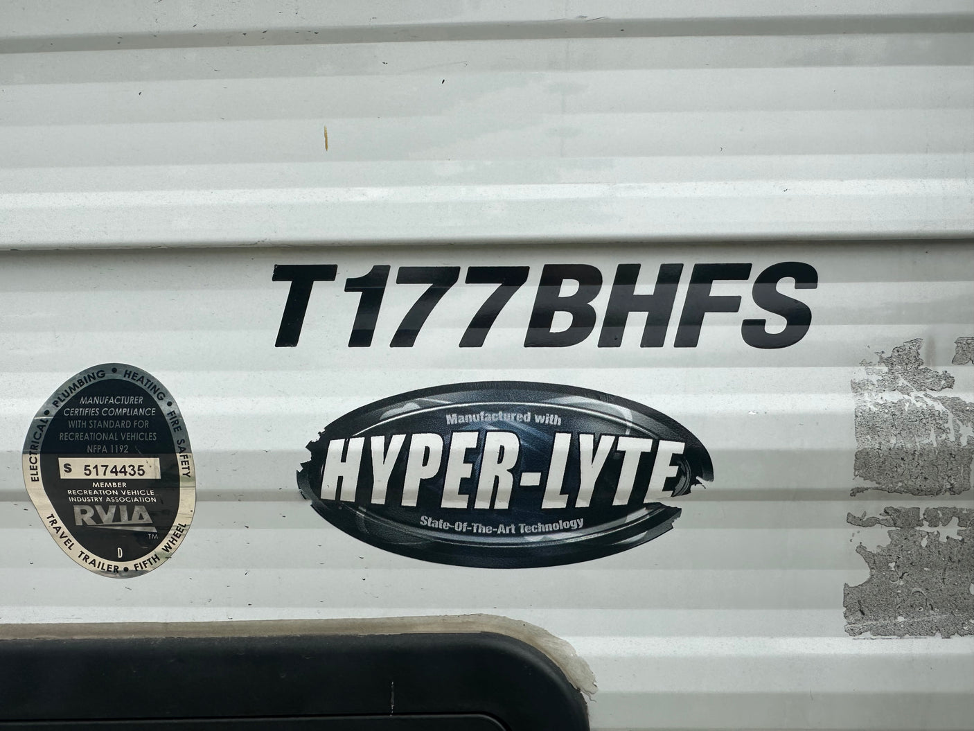 A white T177BHFS travel trailer, an RVIA-certified Hyper-Lyte model, suitable for an rv rental adventure.