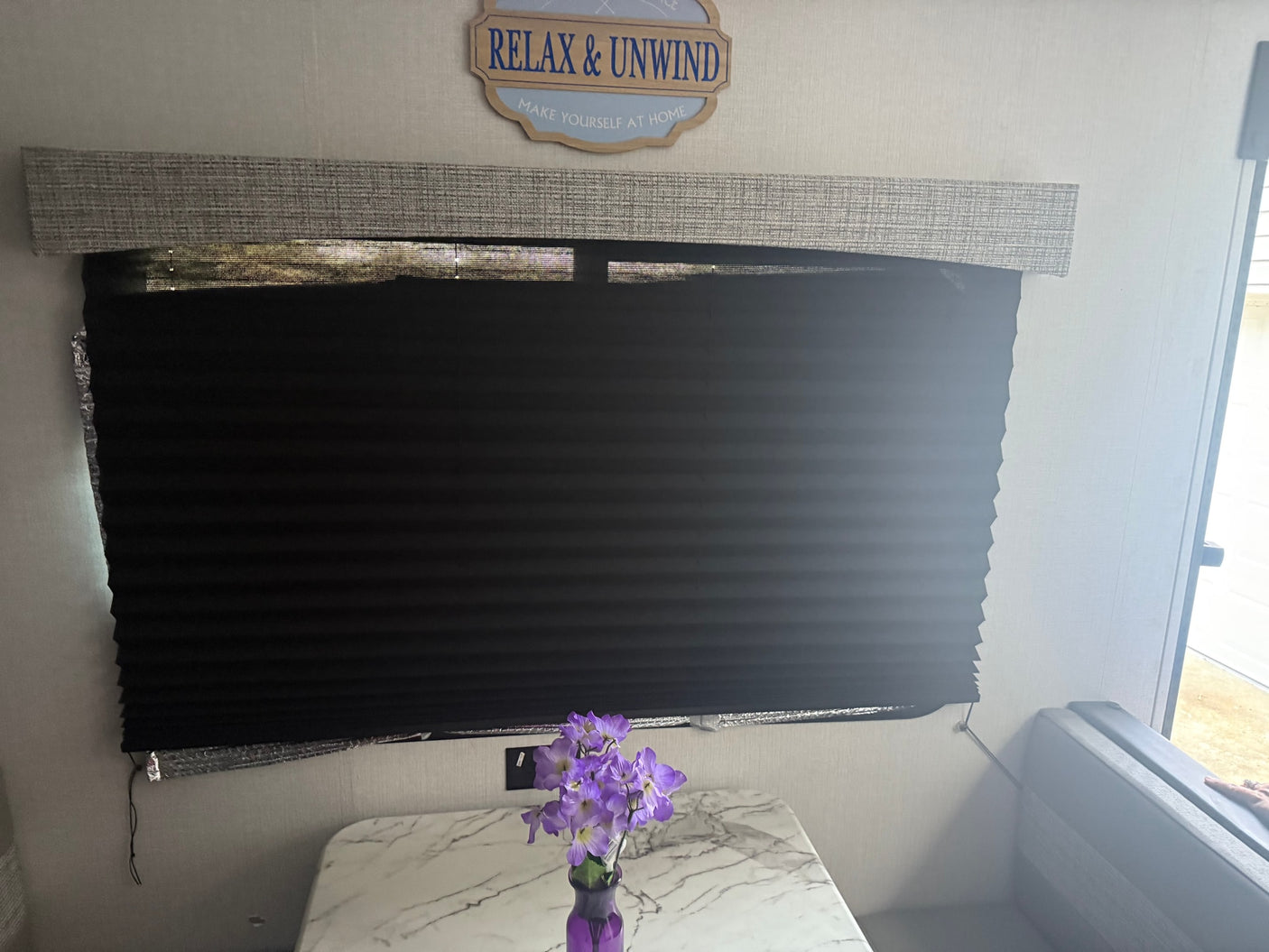 and windows on both sides.|Cozy RV rental dinette with window view