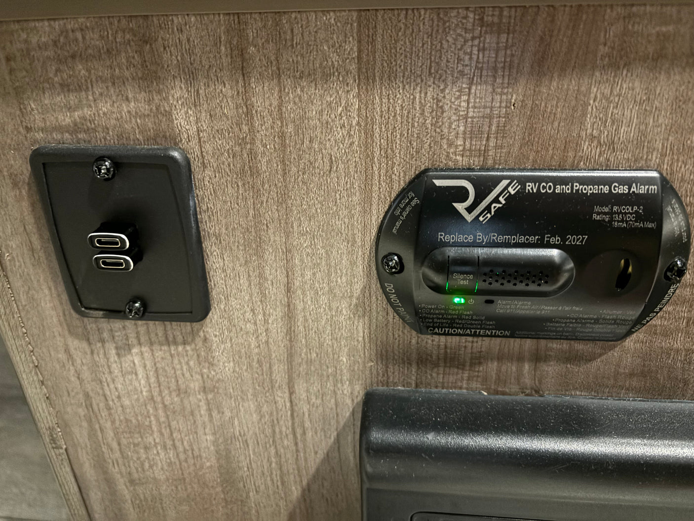RV rental interior with active CO/propane alarm & convenient dual USB-C charger for guests.