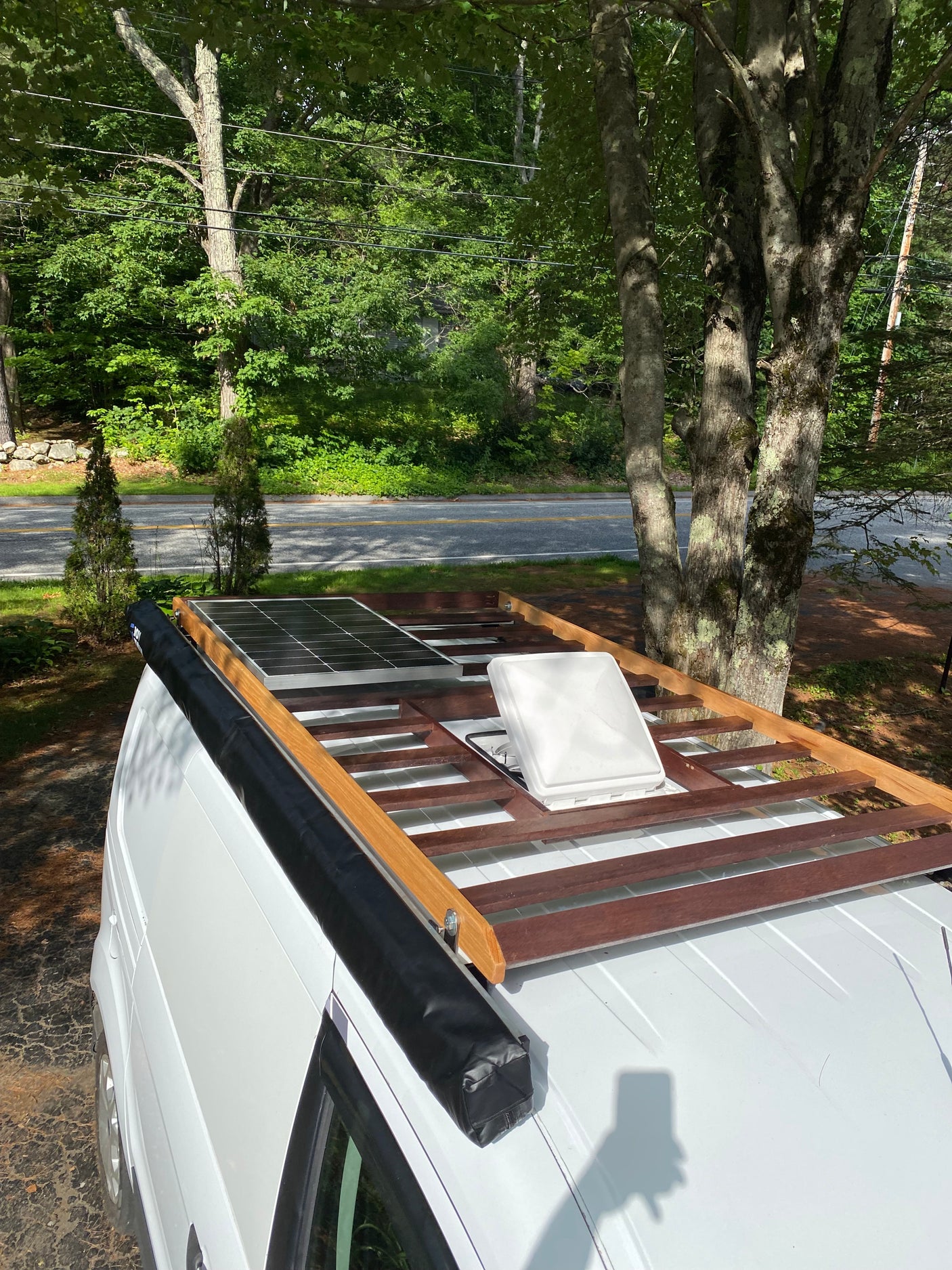 This RV rental features a roof-mounted solar panel, awning, and vent, ready for off-grid adventures.