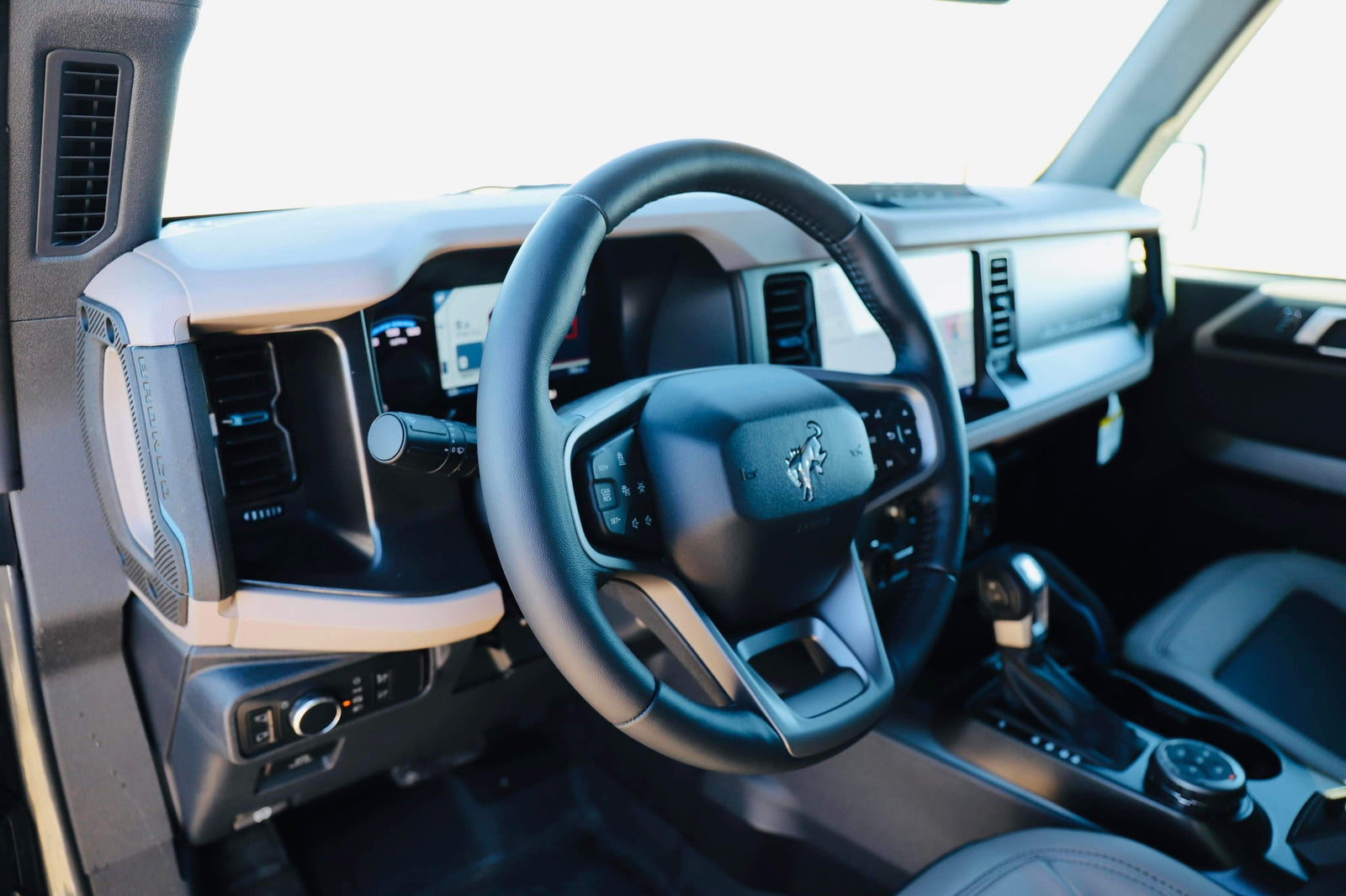 Detailed interior of a modern SUV, showing the steering wheel & digital dash. Enhance your next adventure or rv rental trip.