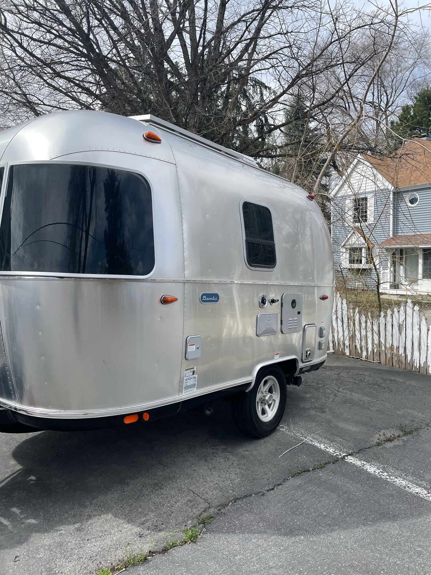 and window view with emergency exits.|Enjoy this clean RV rental interior with dining table and cozy benches — photo 9