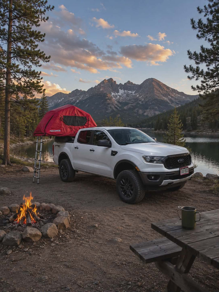 and campfire.|White Ford pickup with a rooftop tent overlooks a mountain lake. Great RV rental for off-grid camping & adventure travel.|Scenic camping adventure! White pickup with rooftop tent