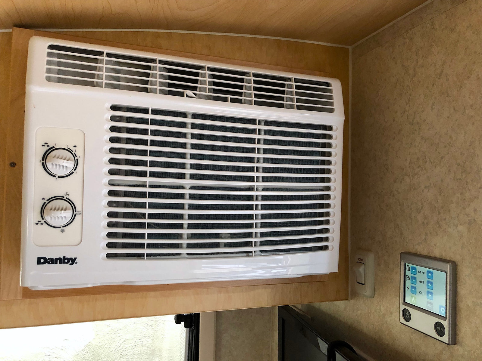 Danby AC unit and digital climate controls in an RV rental. Essential for maintaining comfort while traveling.
