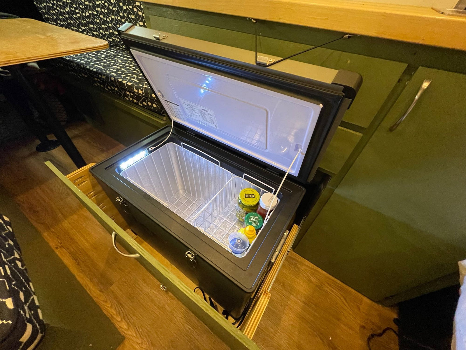 ideal for travel.|Smart RV rental setup: a built-in pull-out portable fridge/freezer