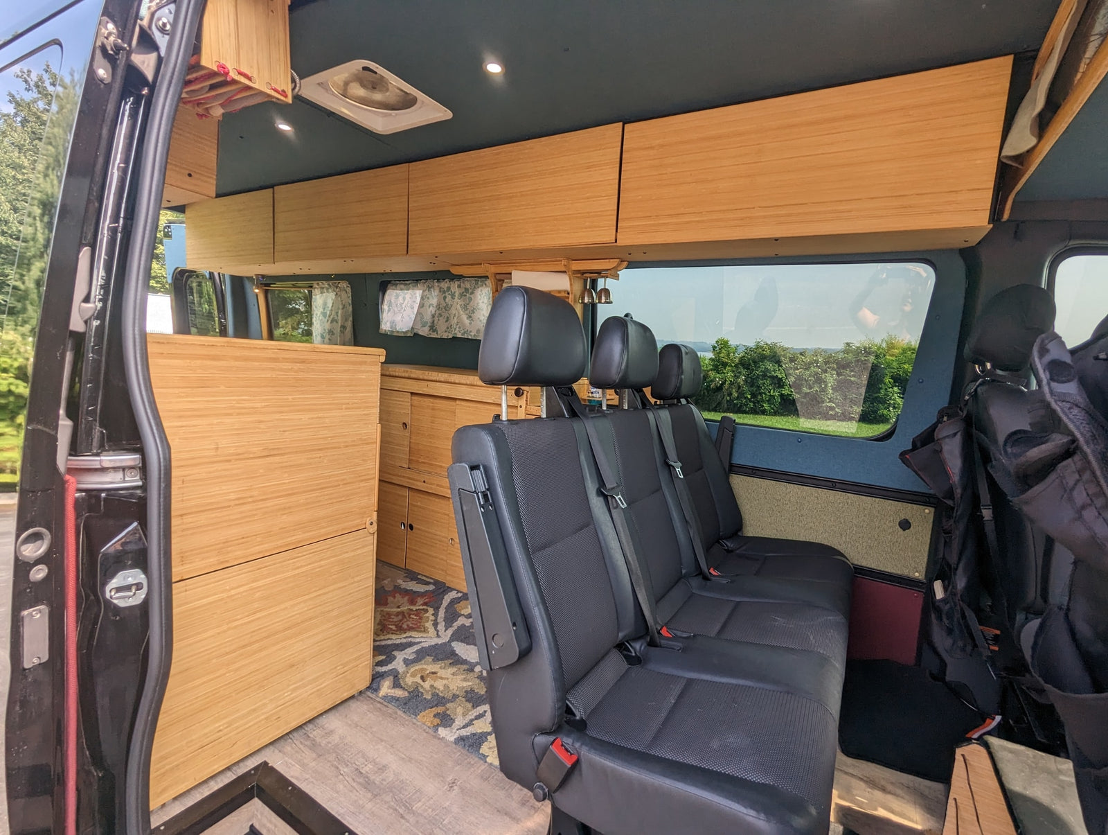 and organized living space.|Black Mercedes Sprinter RV rental by a river