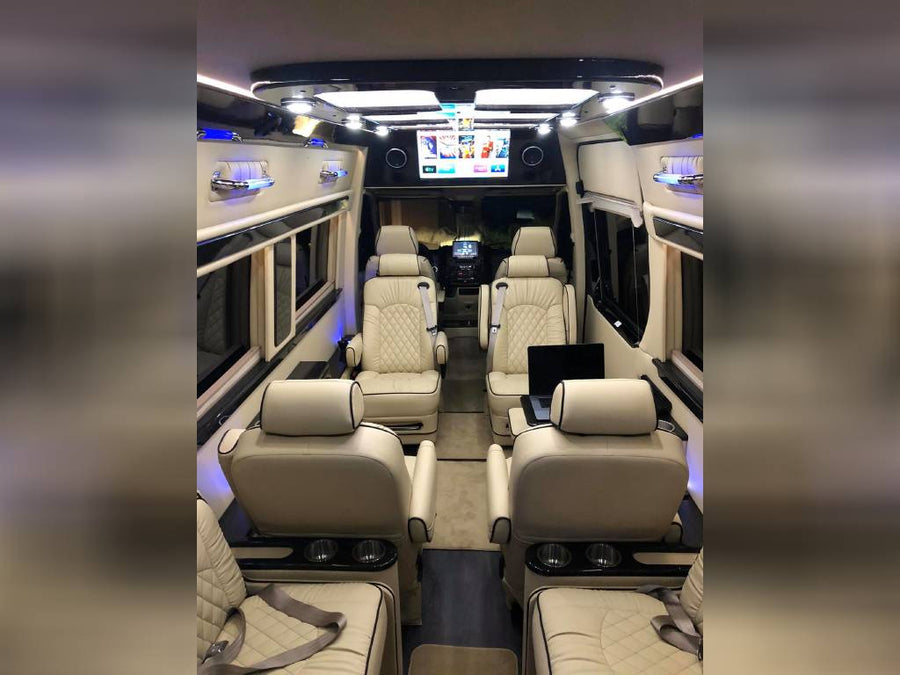 ideal for group travel.|Luxurious RV rental interior: cream captain's chairs