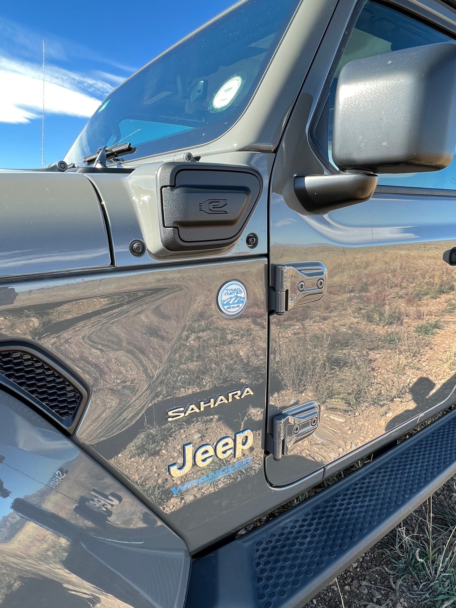 Close-up of a rugged gray Jeep Wrangler Sahara 4x4, perfect for off-road exploration and complementing an RV rental trip.