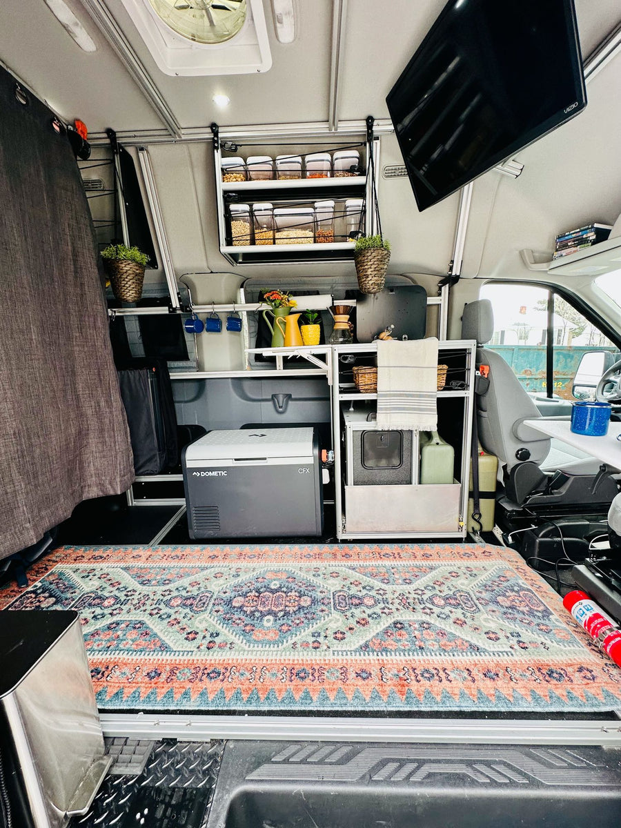 with majestic snow-capped mountains and blue sky.|Explore mobile living in this organized camper van RV rental. Features compact kitchen
