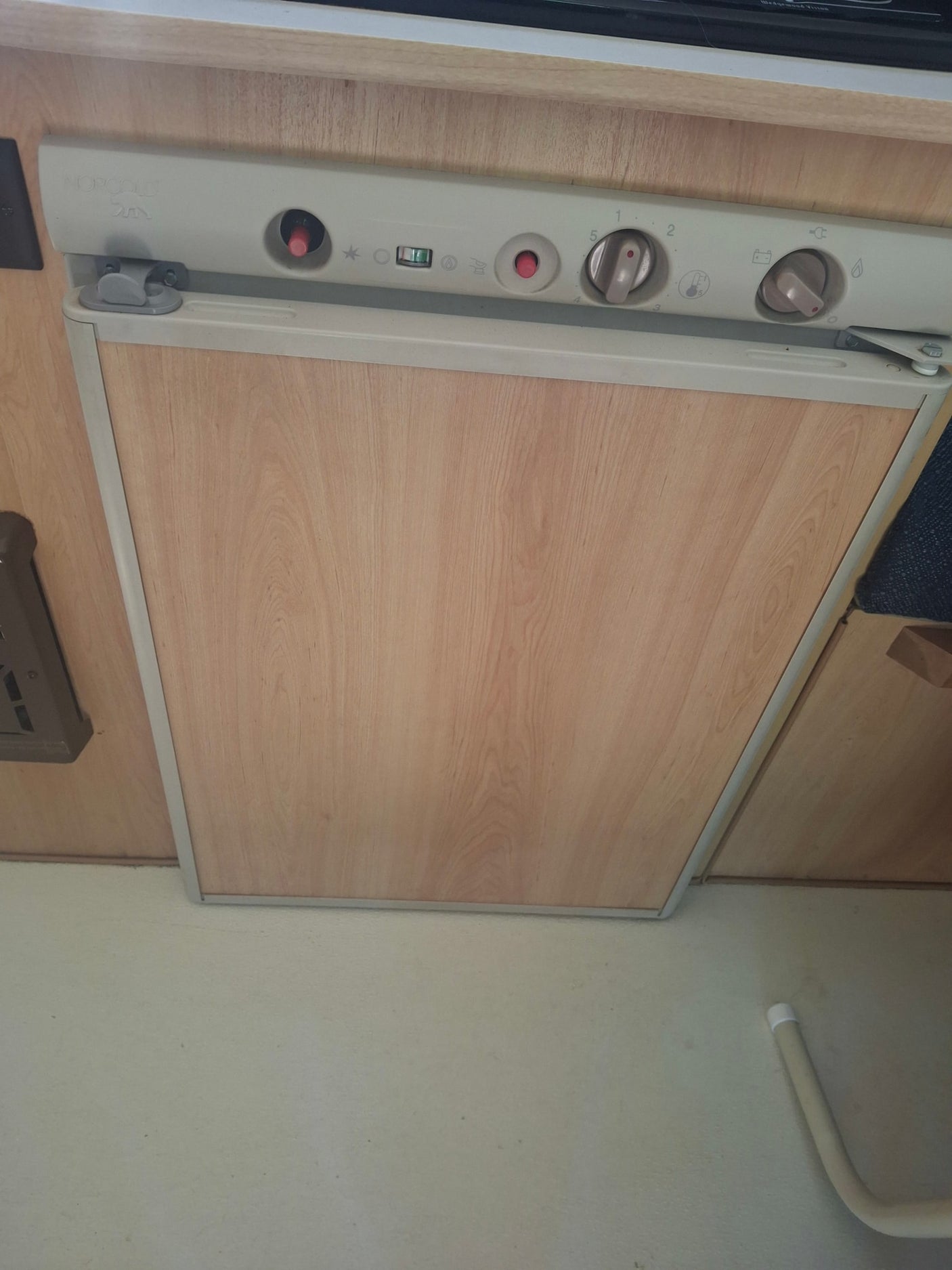 and window.|RV rental interior: cozy sleeping area with storage