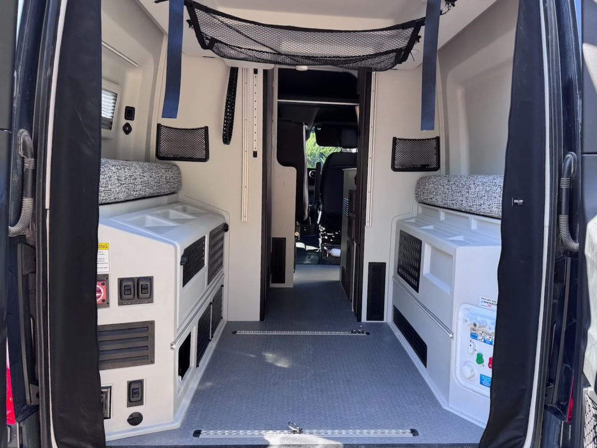 with side door open revealing its custom interior kitchen setup. Ready for adventure!|Sunny day view of a gray RV rental camper van with its side door open — photo 9