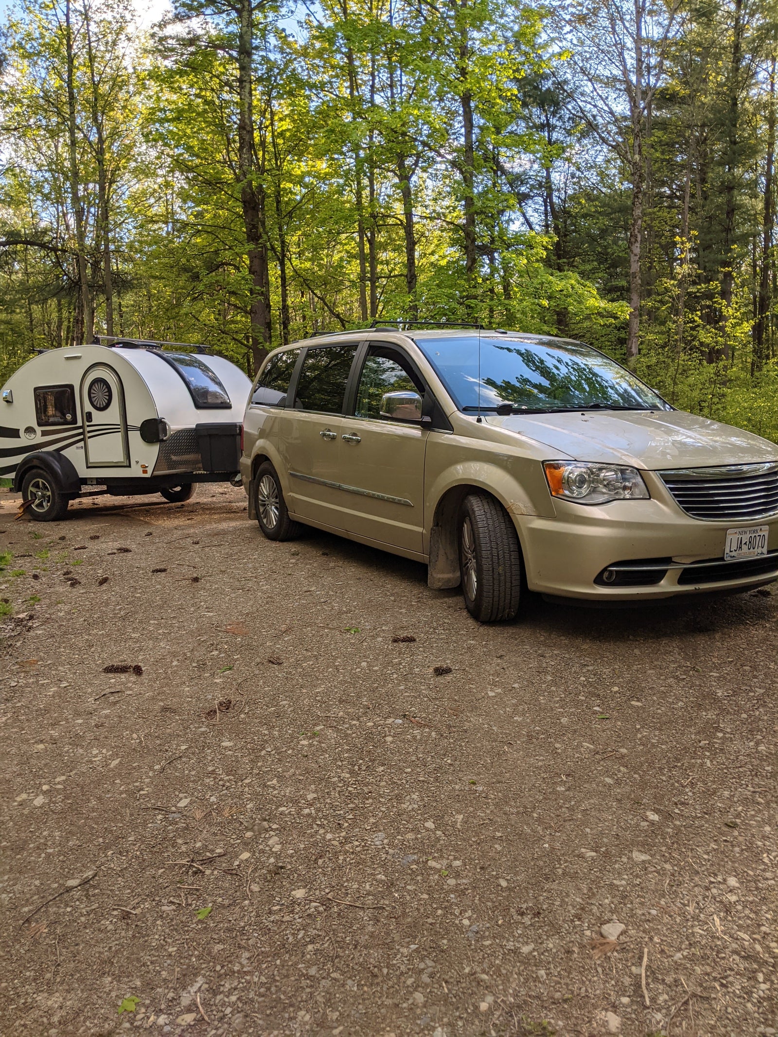 great for camping.|White teardrop camper rv rental at a wooded campsite