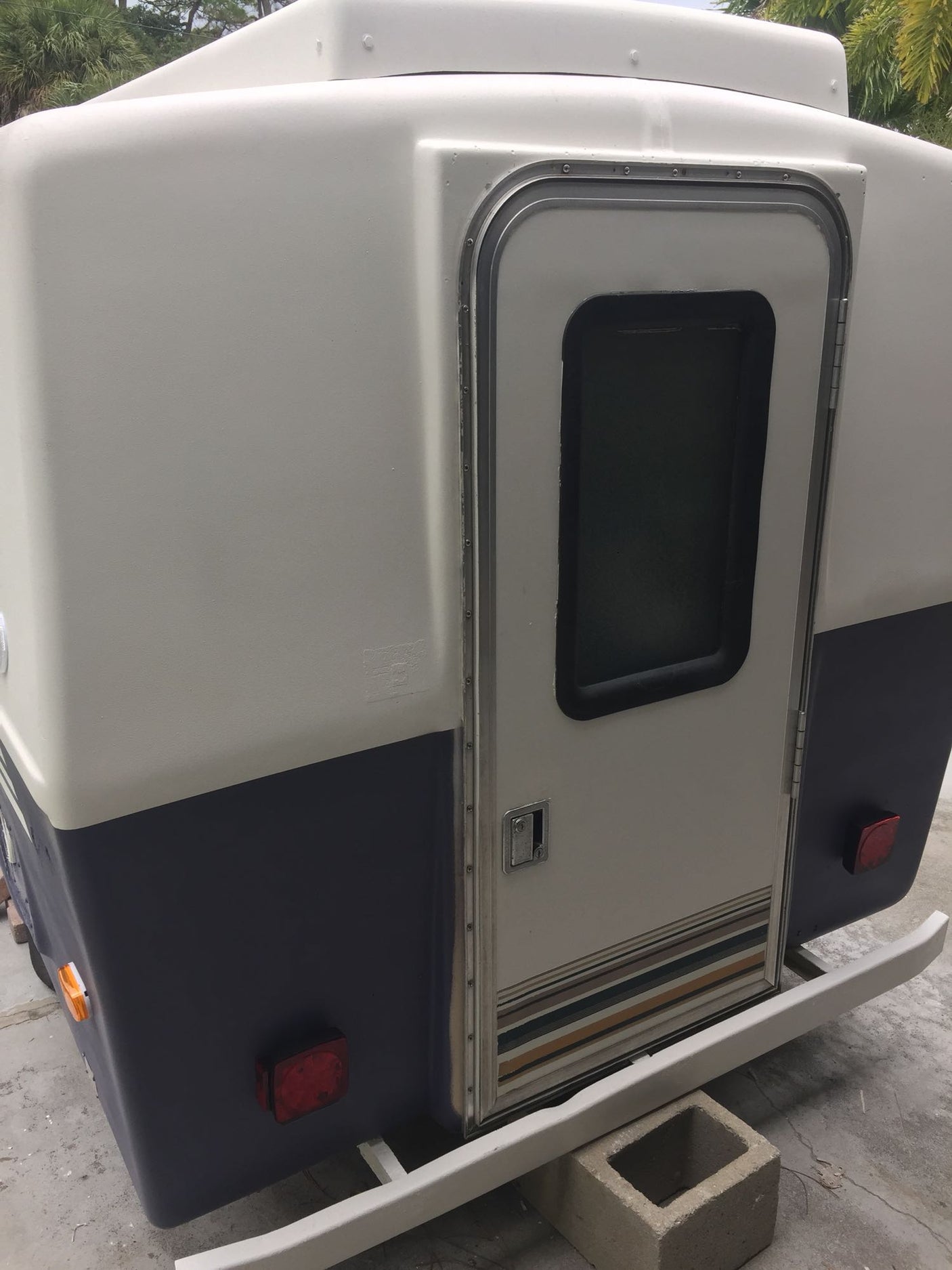 and person setting up by a lake.|Compact rv rental interior with bed