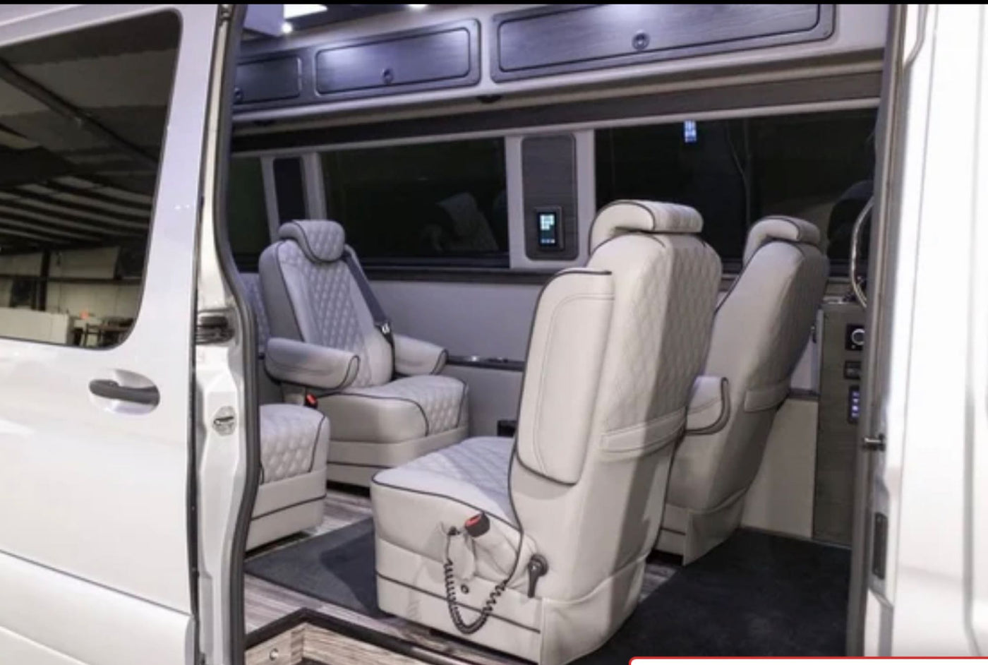 Luxurious custom van interior, perfect for an RV rental. Features premium quilted seating, ample space, and overhead storage. — photo 5