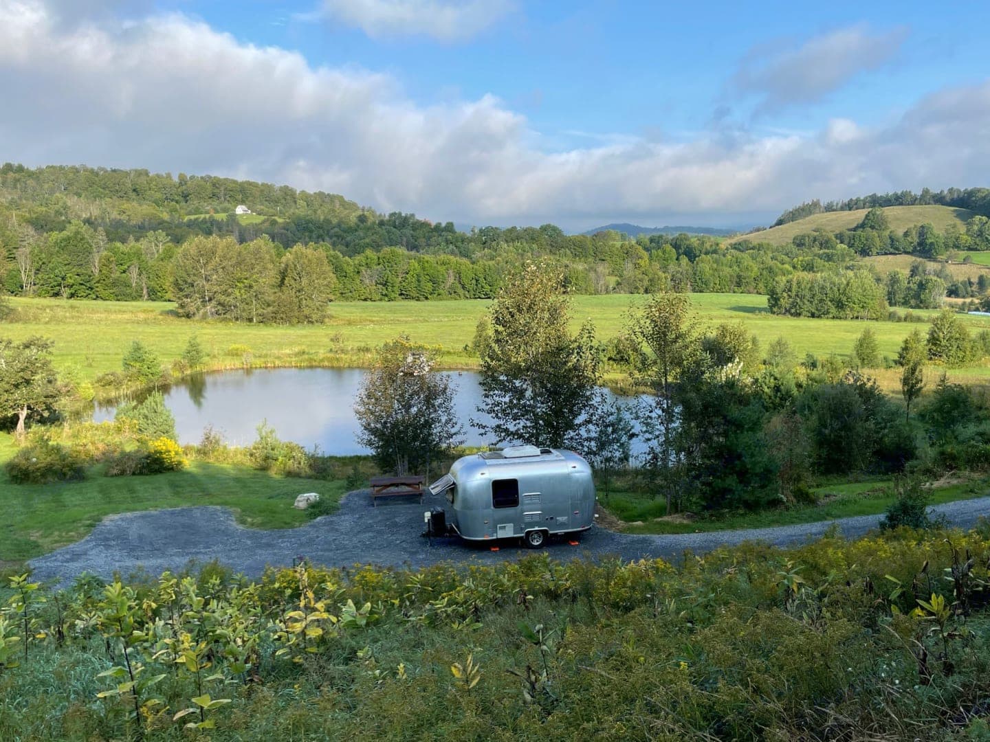 and smart storage for comfortable travel.|Cozy RV rental interior with a striped bed