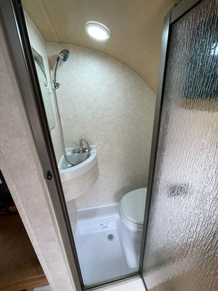 and cooler for travel.|Inside an RV rental showing a light wood dinette
