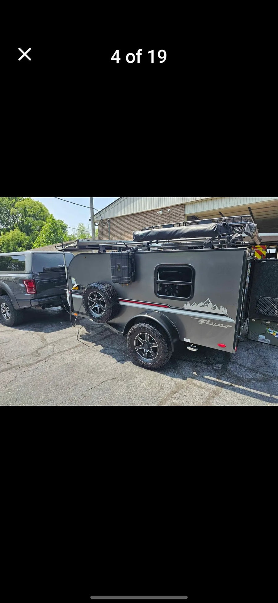 Gray pickup truck towing a rugged off-road teardrop camper. Ideal RV rental for your next outdoor adventure.