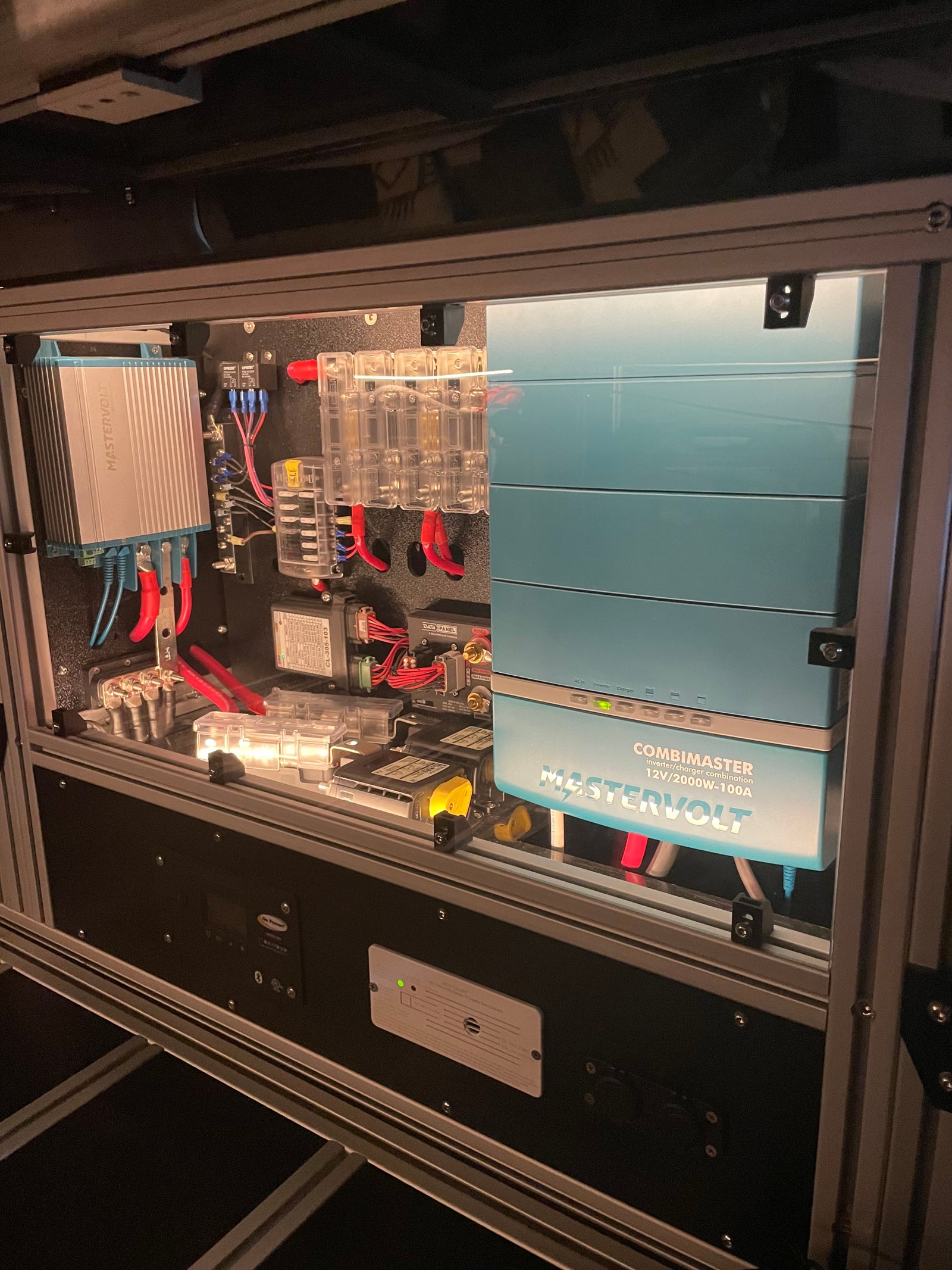 Advanced Mastervolt power system in an RV rental, showing a CombiMaster inverter/charger, multiple fuses, and wiring for efficient power management.