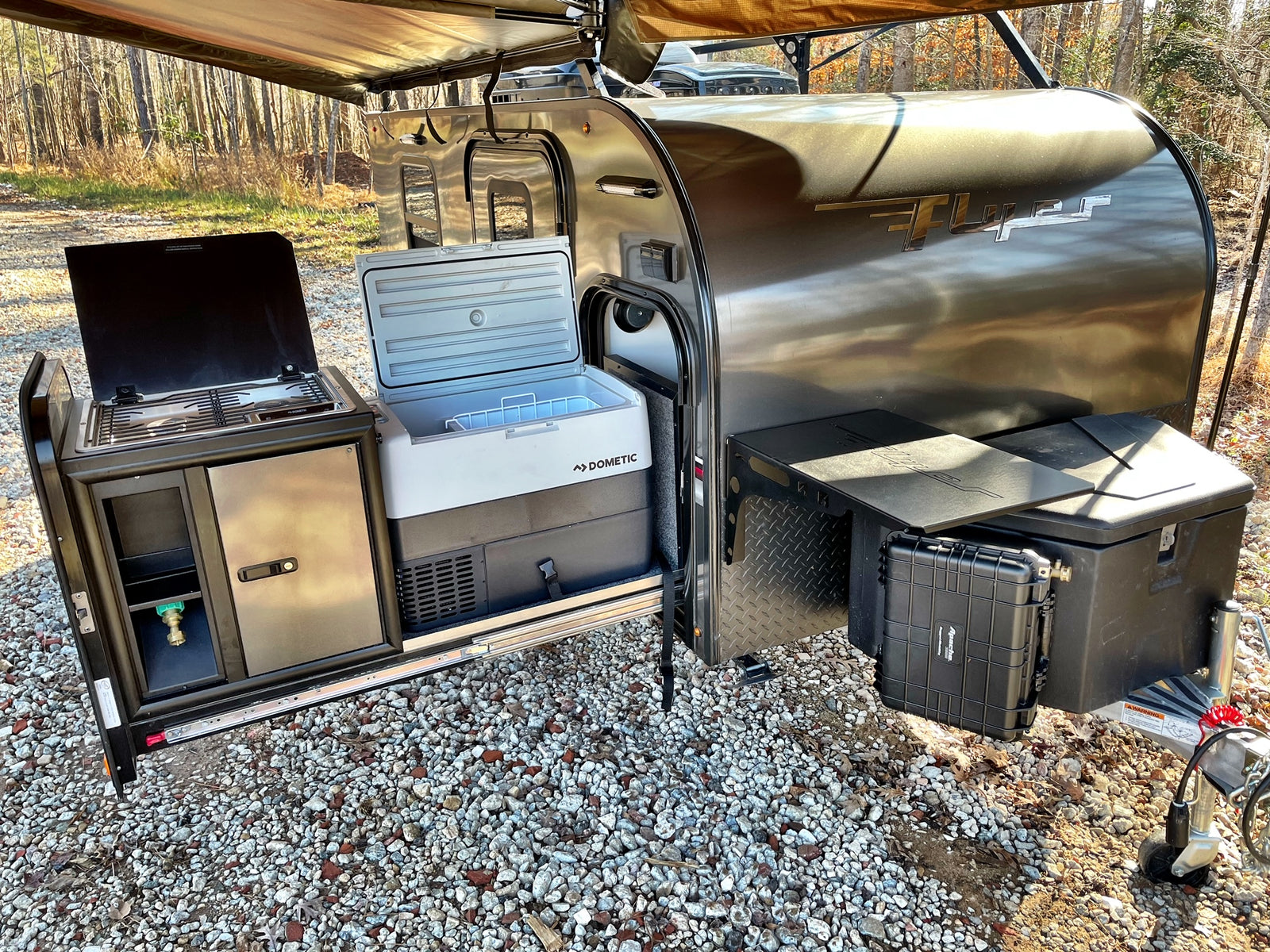Compact Flyer RV rental with an amazing pull-out outdoor kitchen, Dometic cooler, and gear storage for overland camping.