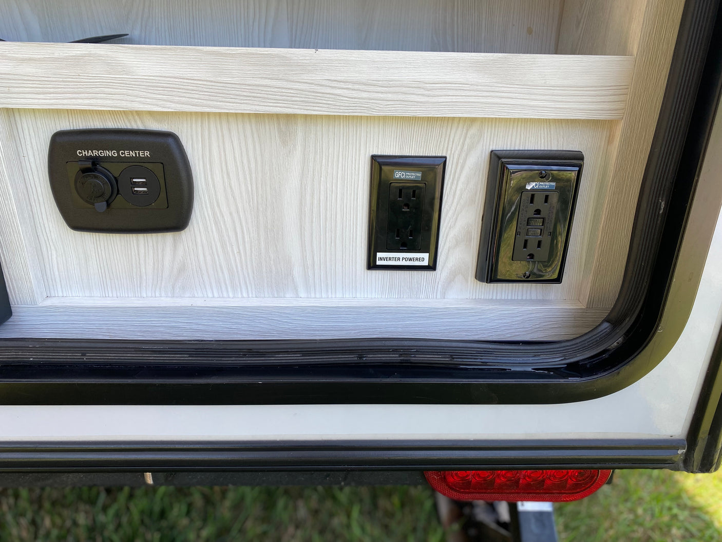 An rv rental charging station with USB/12V ports and GFCI inverter-powered outlets for convenient power.
