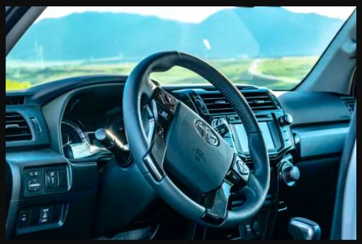 parked in a scenic mountain landscape.|White Titus SUV with rooftop tent in scenic landscape. Your perfect rv rental for mountain adventures!|SUV interior