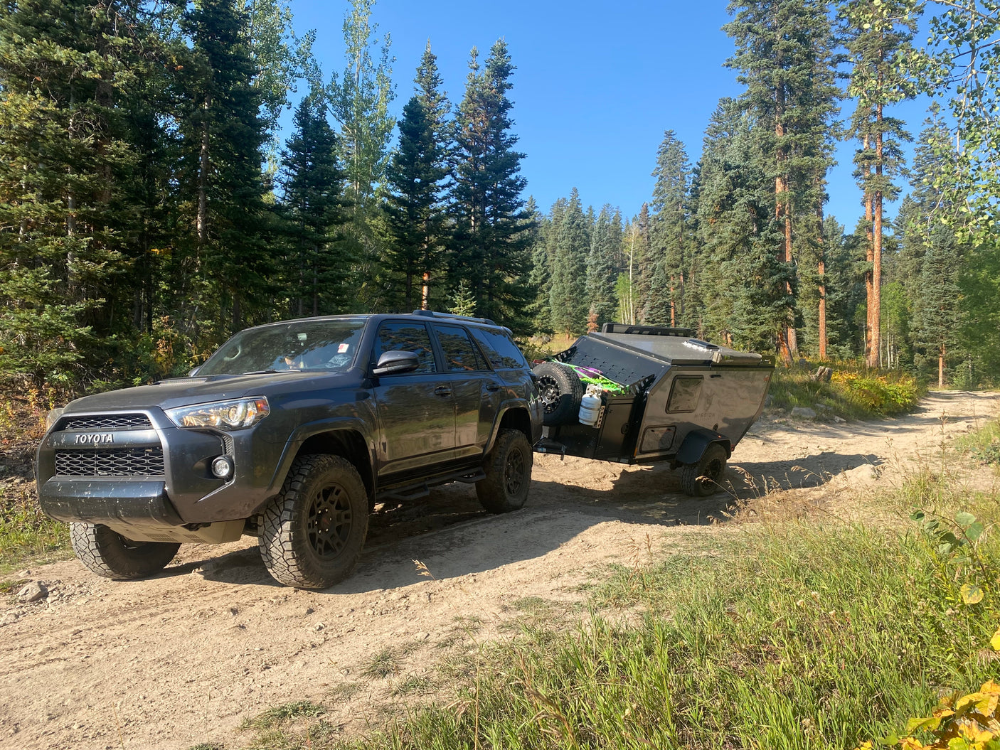 Explore off-road trails with a Toyota 4Runner towing an overland trailer. Consider this setup for an RV rental adventure!