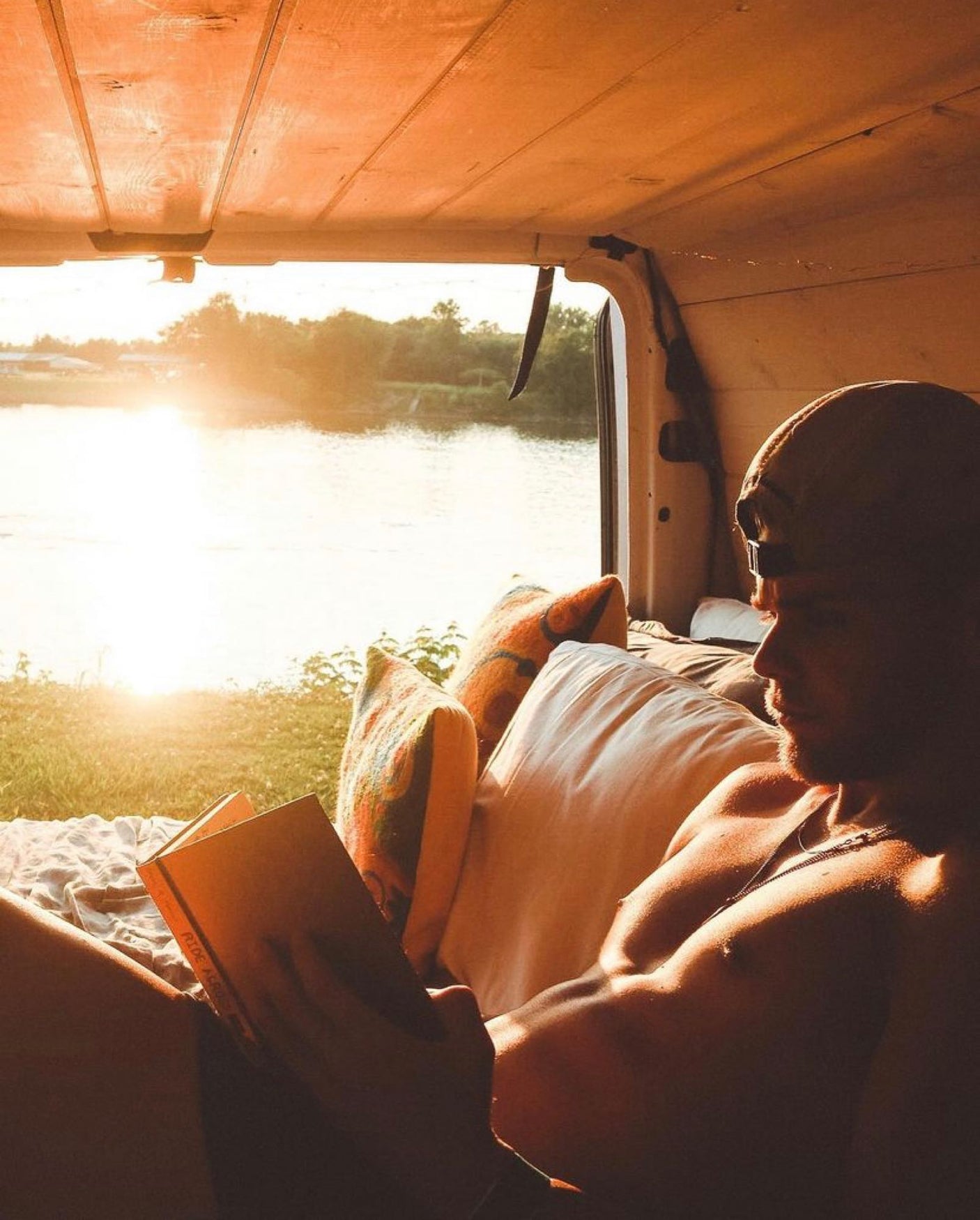& Yeti cooler make van life comfortable.|Enjoy an RV rental adventure! Two men organize their camper van at sunset