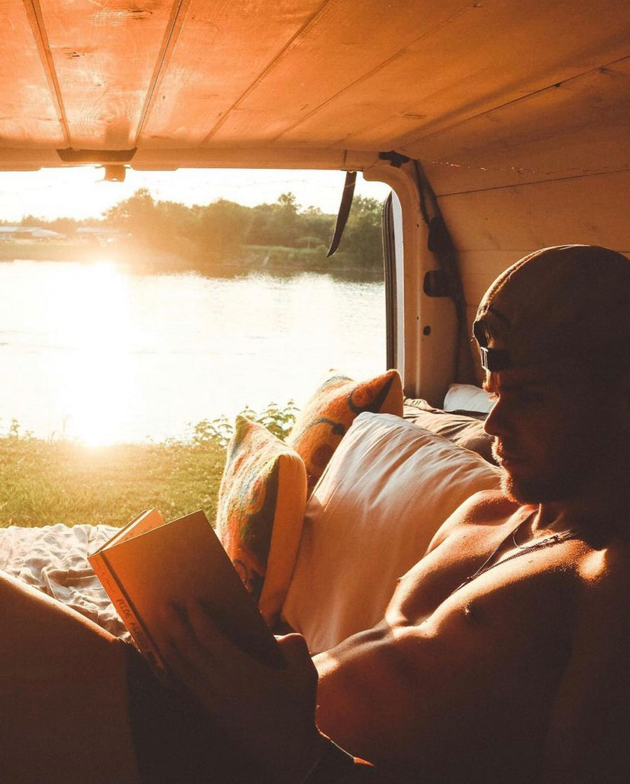 & Yeti cooler make van life comfortable.|Enjoy an RV rental adventure! Two men organize their camper van at sunset