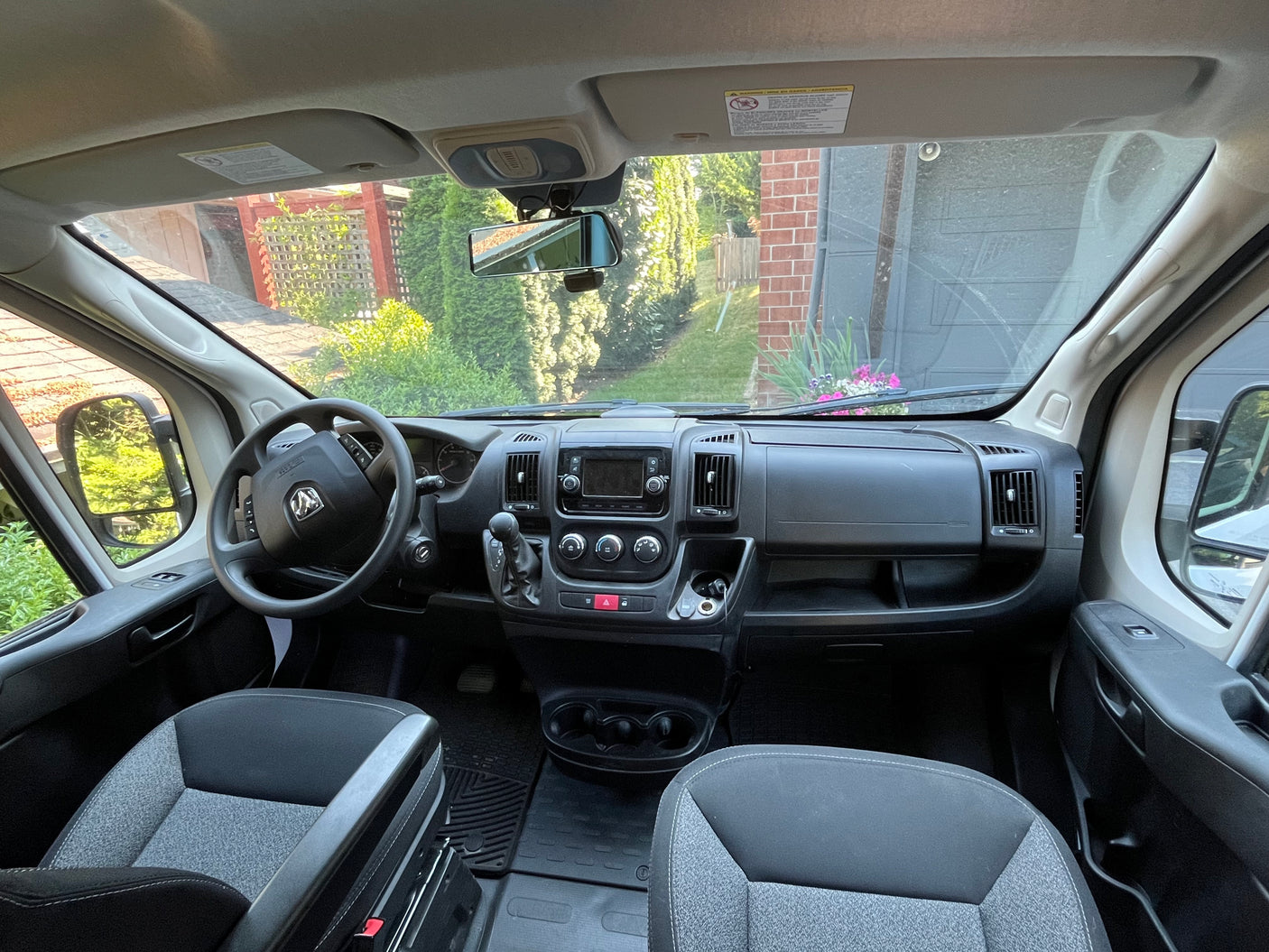 RV rental van interior showing dashboard, steering wheel, and front seats. Ready for adventure!