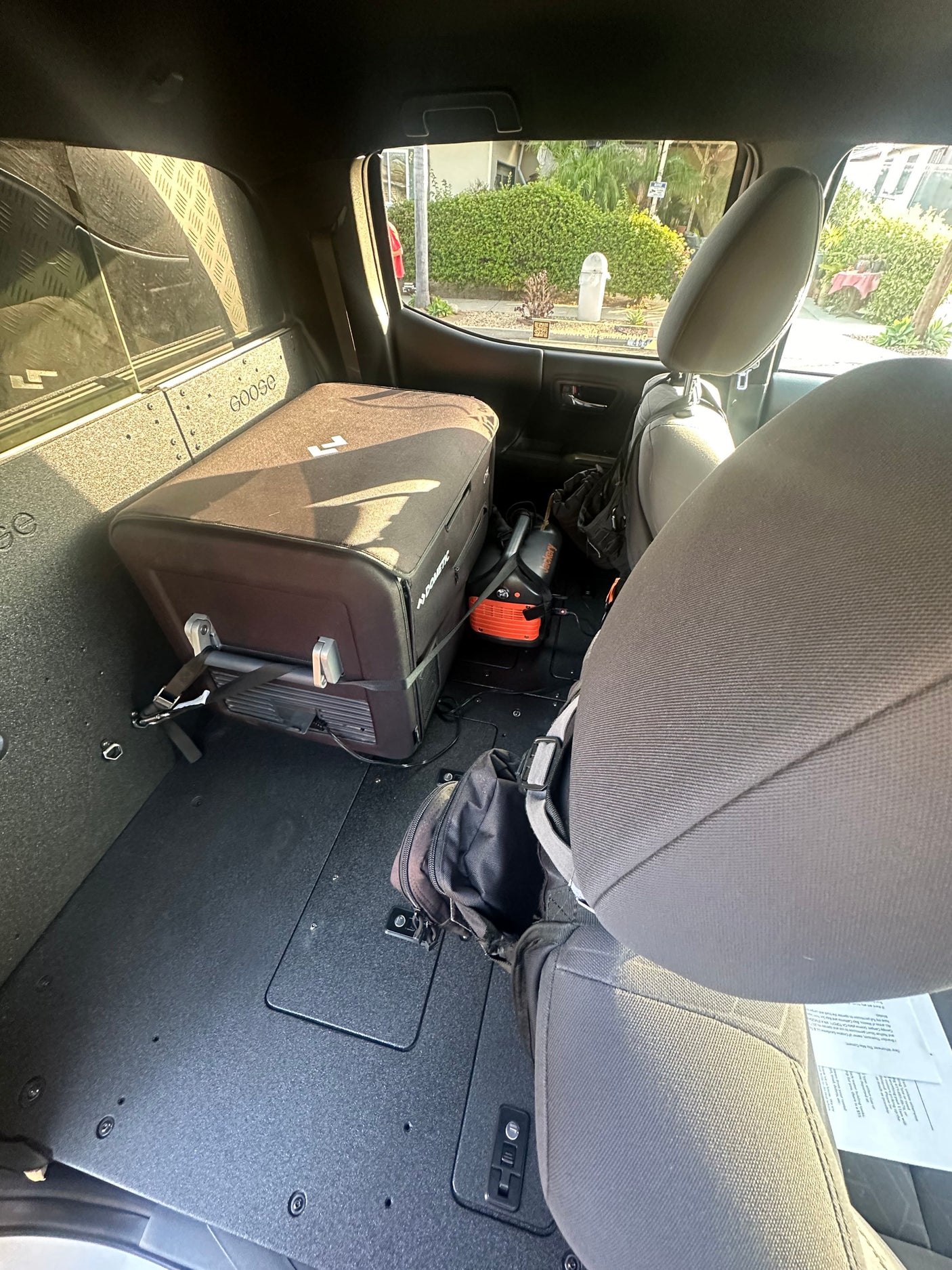 RV rental interior: Dometic fridge & Jackery power station secured in a custom cargo system. Ready for travel.