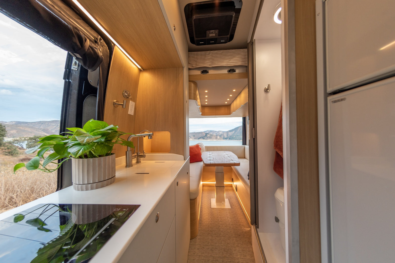 and a functional mobile office.|A compact RV rental interior with a sink