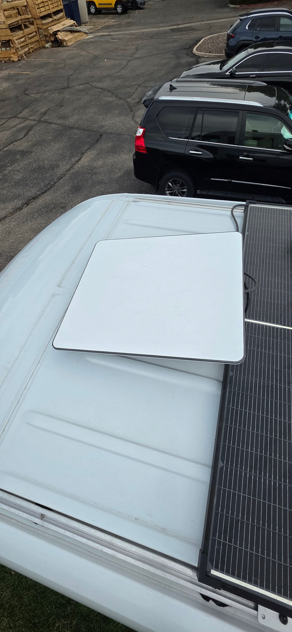 Top-down view of an rv rental roof: Starlink antenna and solar panels for mobile internet & power. — photo 17