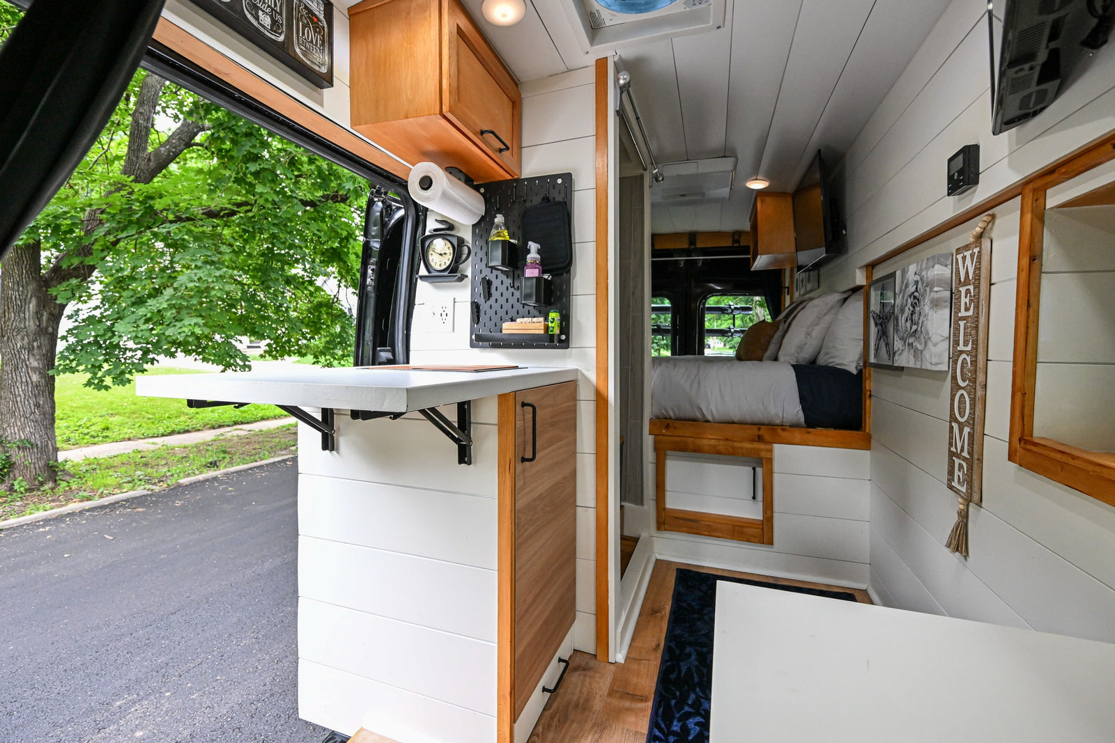 complete with coastal decor and essential controls for your journey.|Black Ford Transit RV rental van