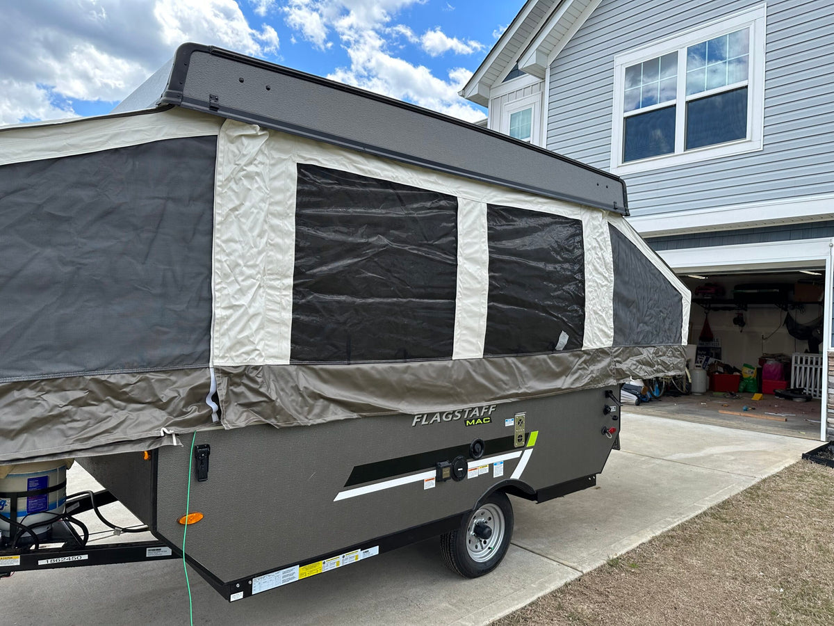 Fully extended pop-up camper, a great RV rental option, parked on a residential driveway next to a gray house. — photo 4