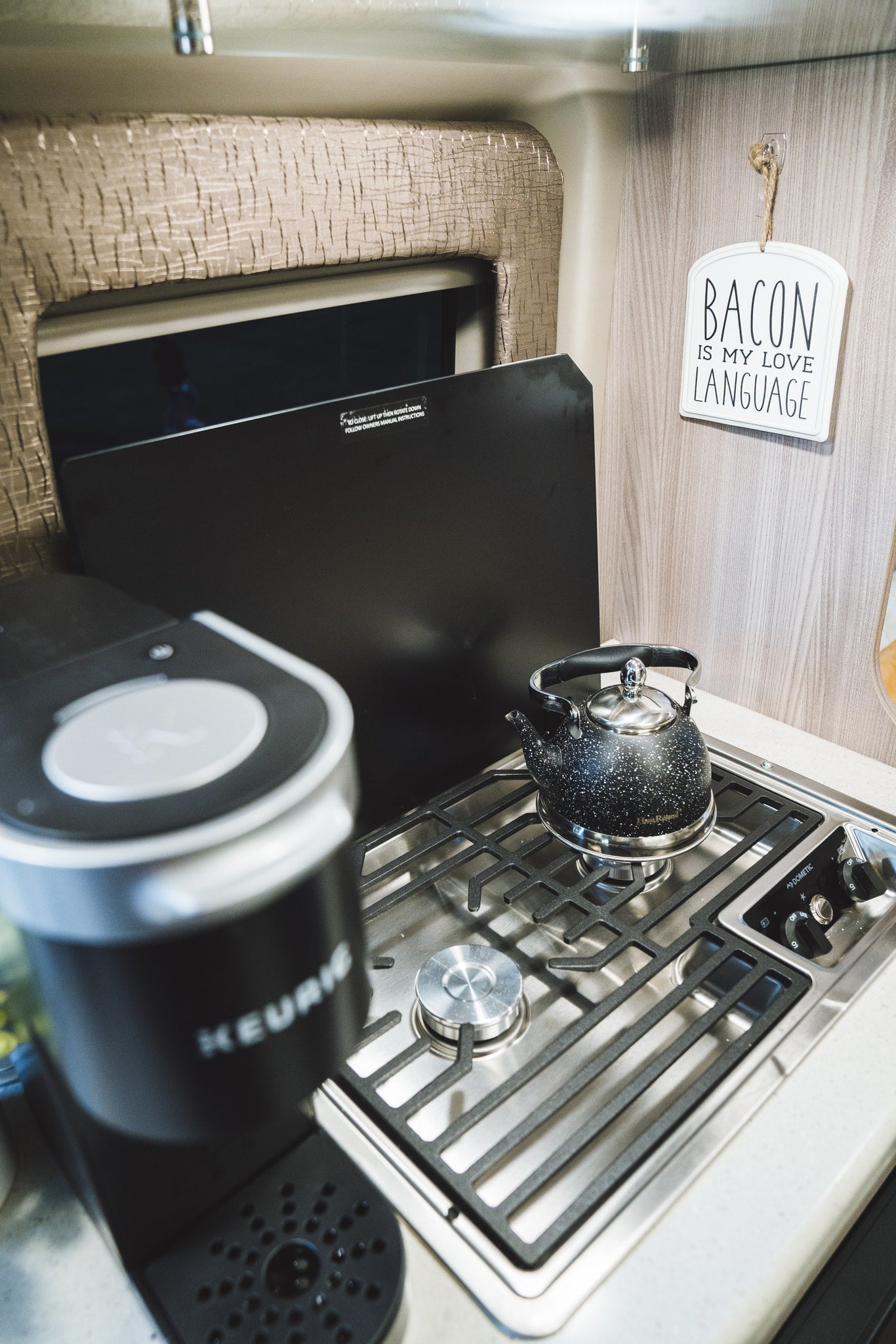 for a bright start in your cozy RV rental.|Cozy RV rental interior showing a kitchenette
