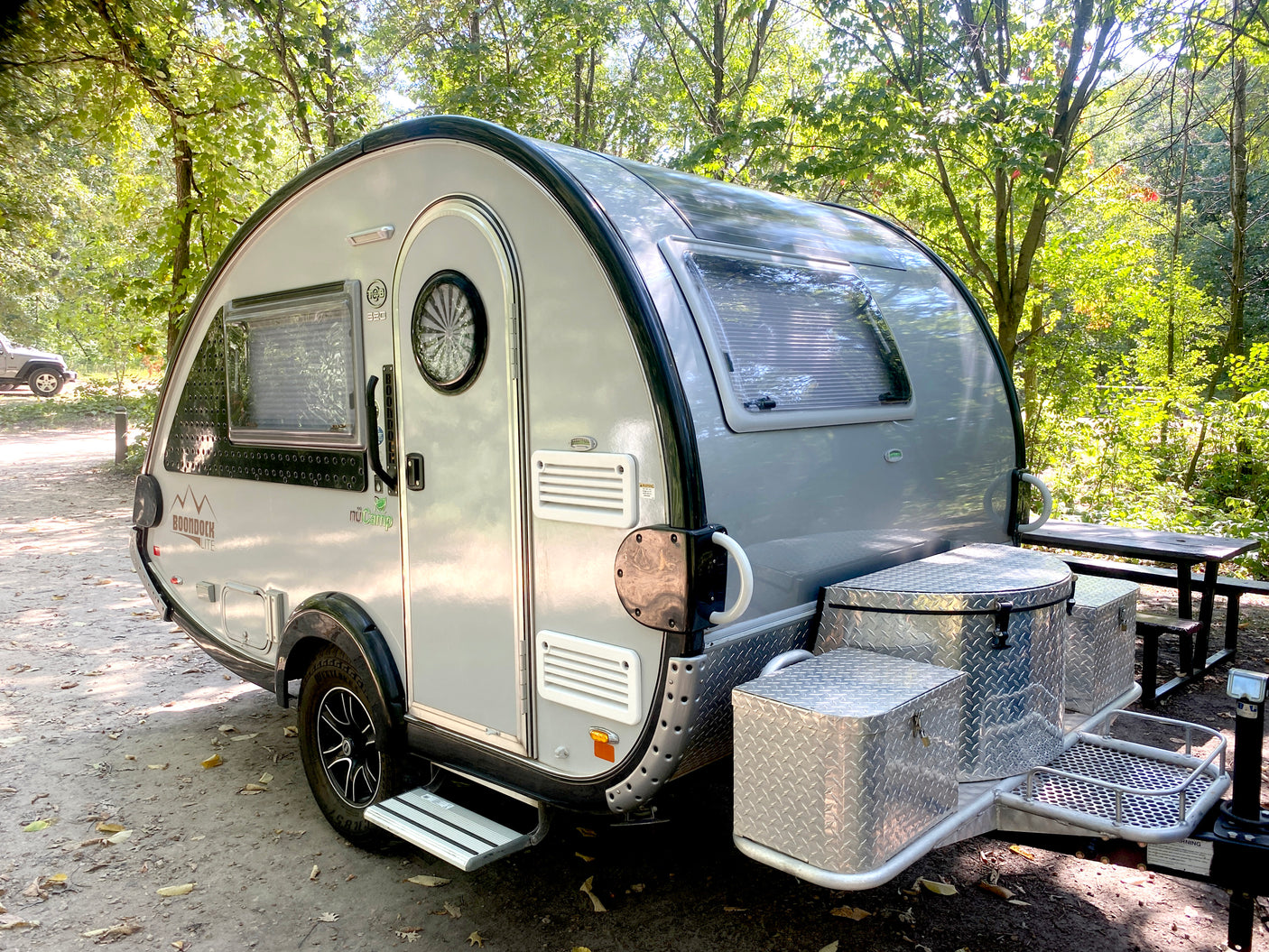 Sleek gray nuCamp Boondock LITE teardrop camper, perfect for your next rv rental outdoor escape.