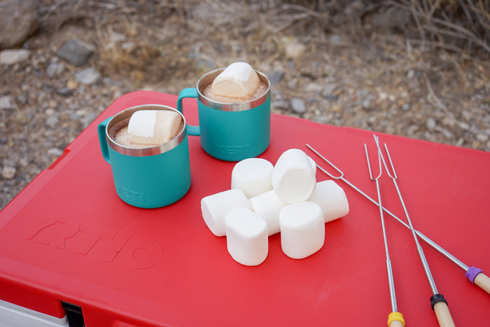 Perfect RV rental campout: hot chocolate, marshmallows, and roasting sticks ready on the RTIC cooler.
