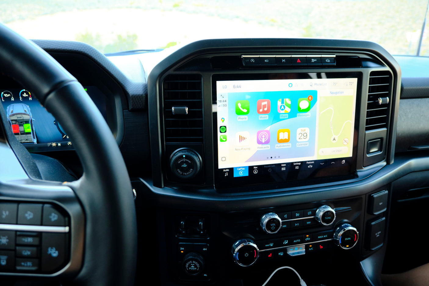 Interior of a vehicle, featuring a large touchscreen with Apple CarPlay navigation and dashboard controls. Perfect for your rv rental adventure.