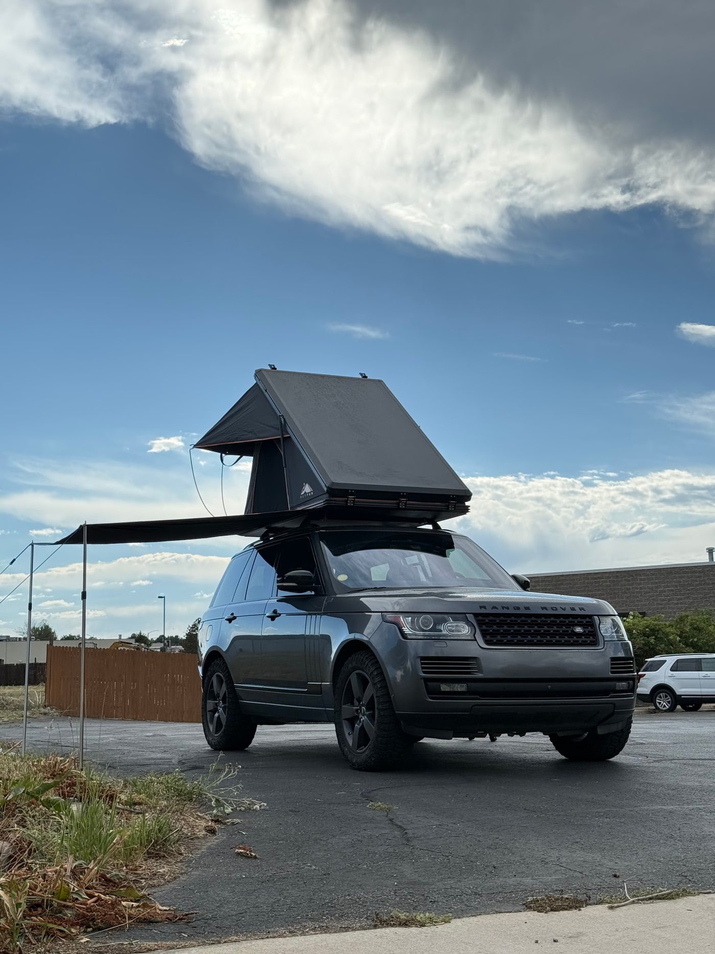 Adventure-ready Range Rover, an RV rental alternative with rooftop tent & awning for outdoor exploration. — photo 7