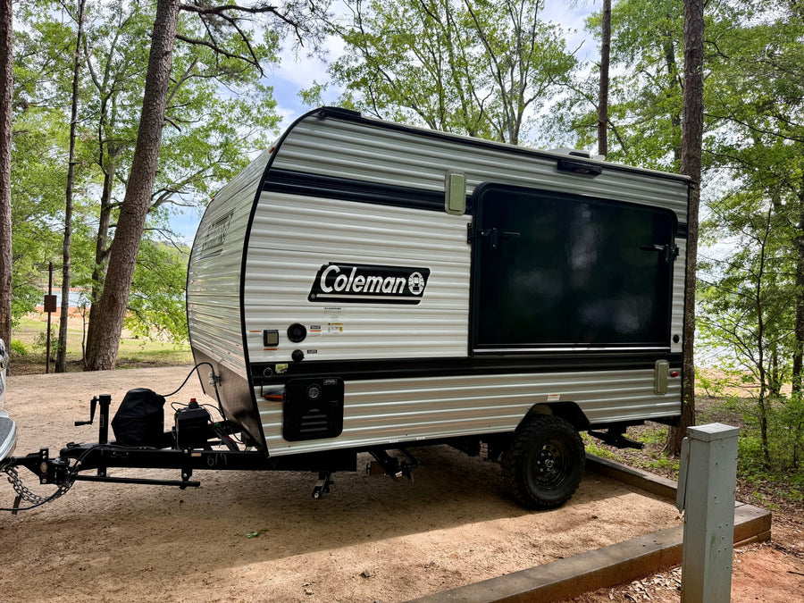 is parked at a scenic wooded campsite next to a lake