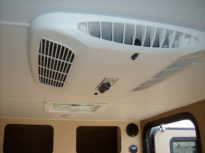 Stay comfortable in your RV rental with this clear view of the ceiling AC unit, featuring cool air vents & user controls.