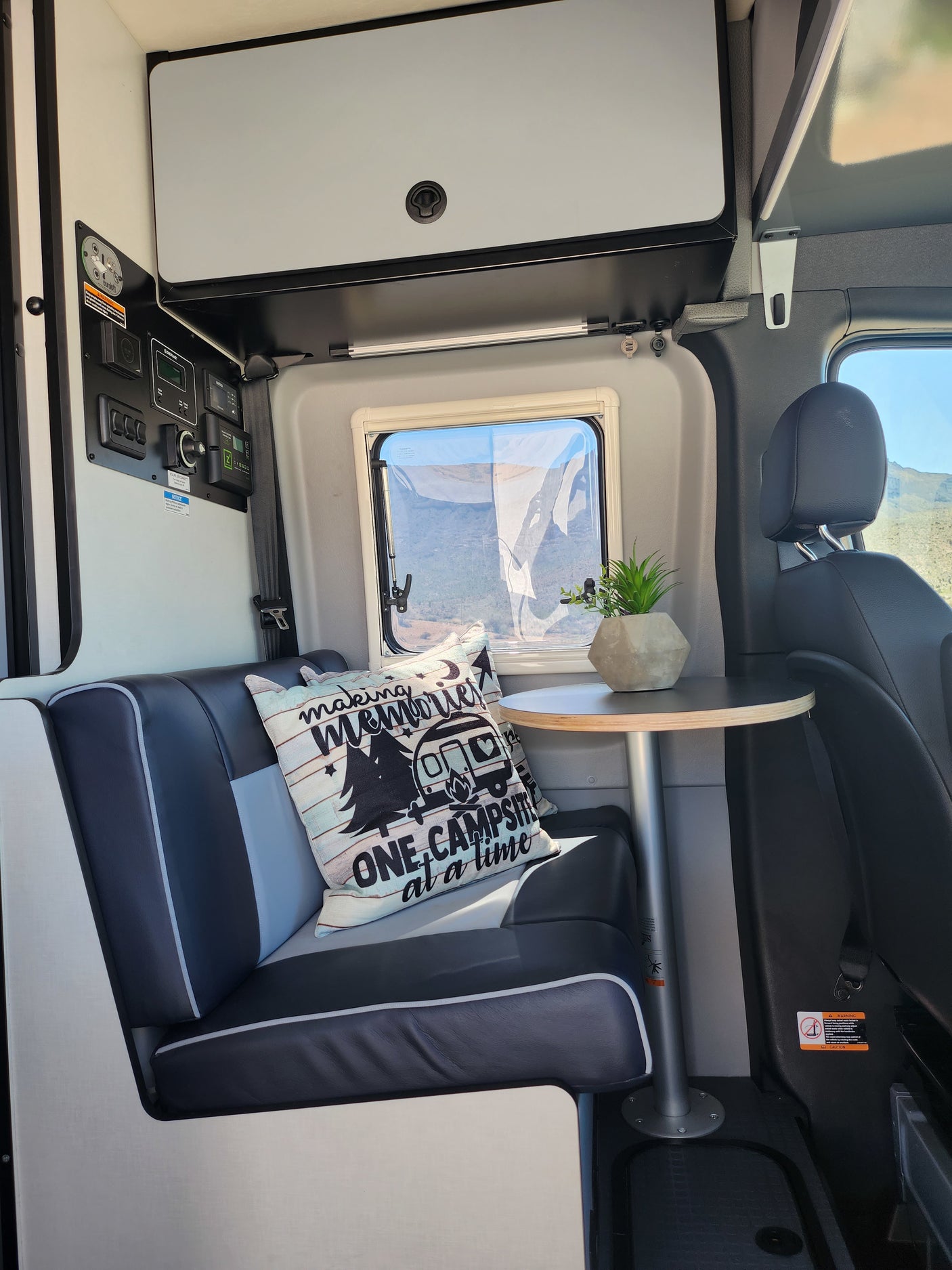 Spacious RV rental interior with a cozy dinette, scenic window