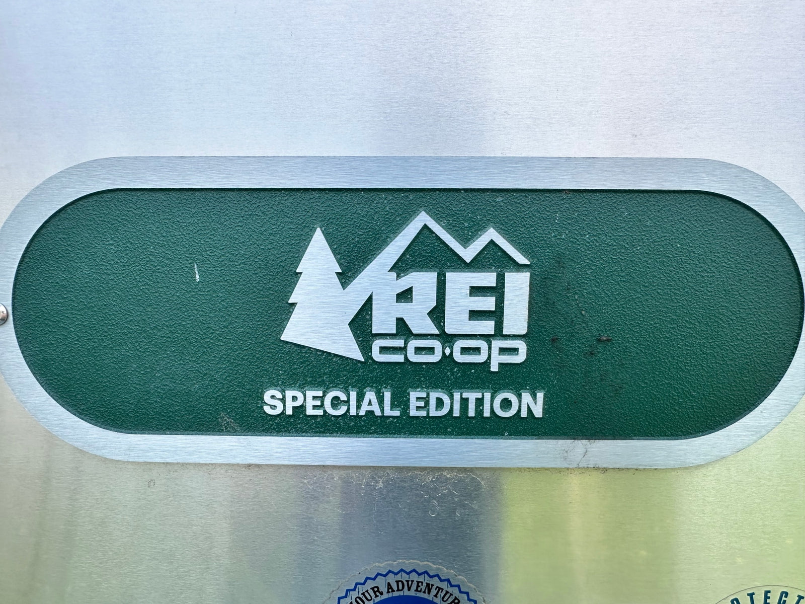 REI Co-op Special Edition emblem on a metallic surface, likely for an RV rental. Ready for your next outdoor adventure.
