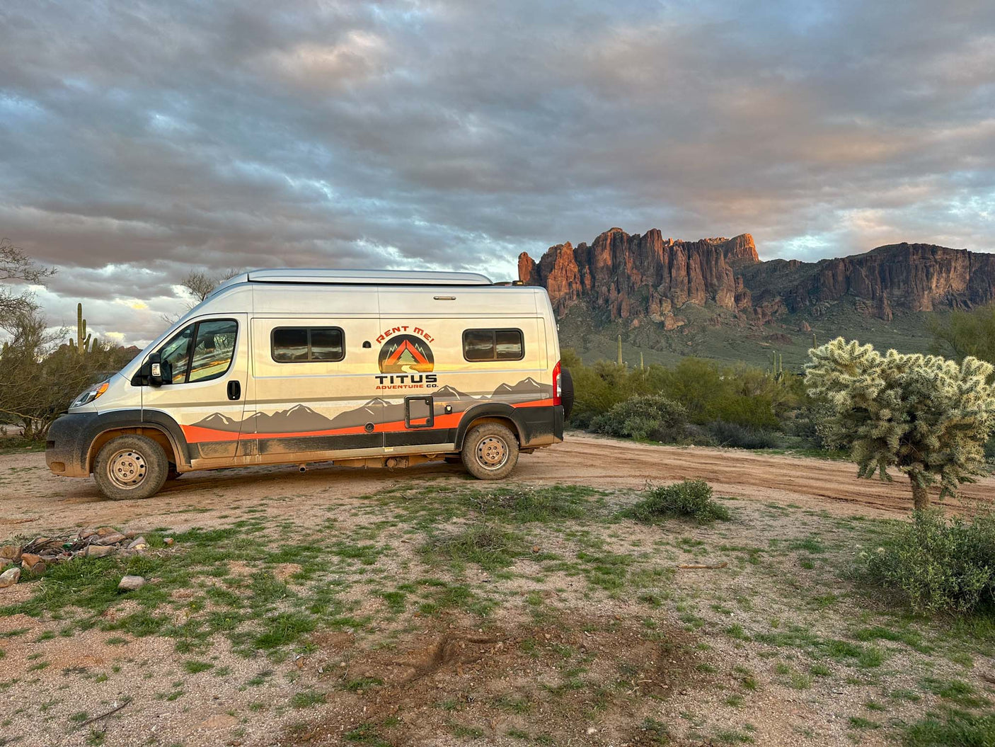 and LP valve switches for comfort and utility.|Cozy sleeping area in an RV rental: a bed with grey pillow under a pop-top roof