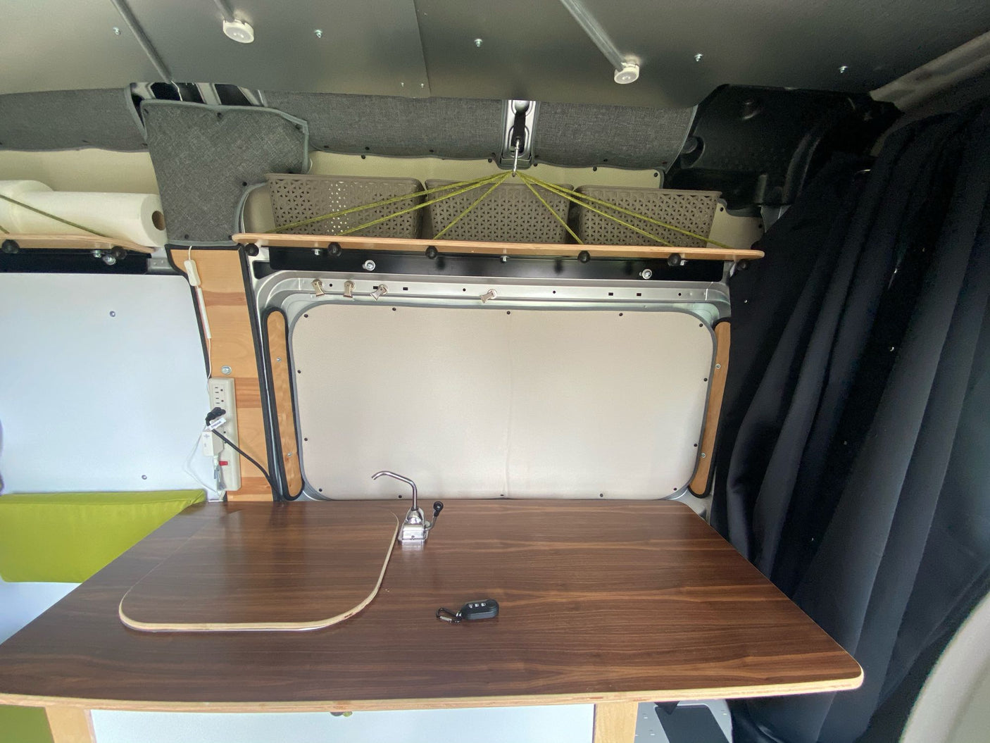 and built-in storage for your journey.|RV rental interior: View of a custom camper van cockpit with swivel seats