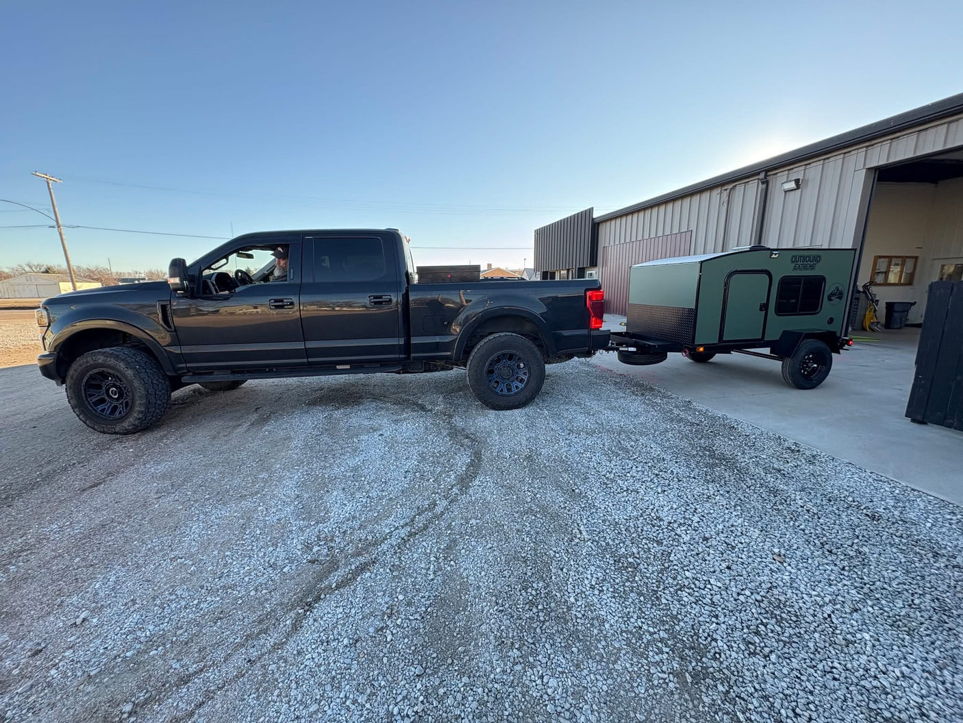 and spare tire mounted underneath on a concrete floor.|Cozy RV rental interior with a comfortable bed