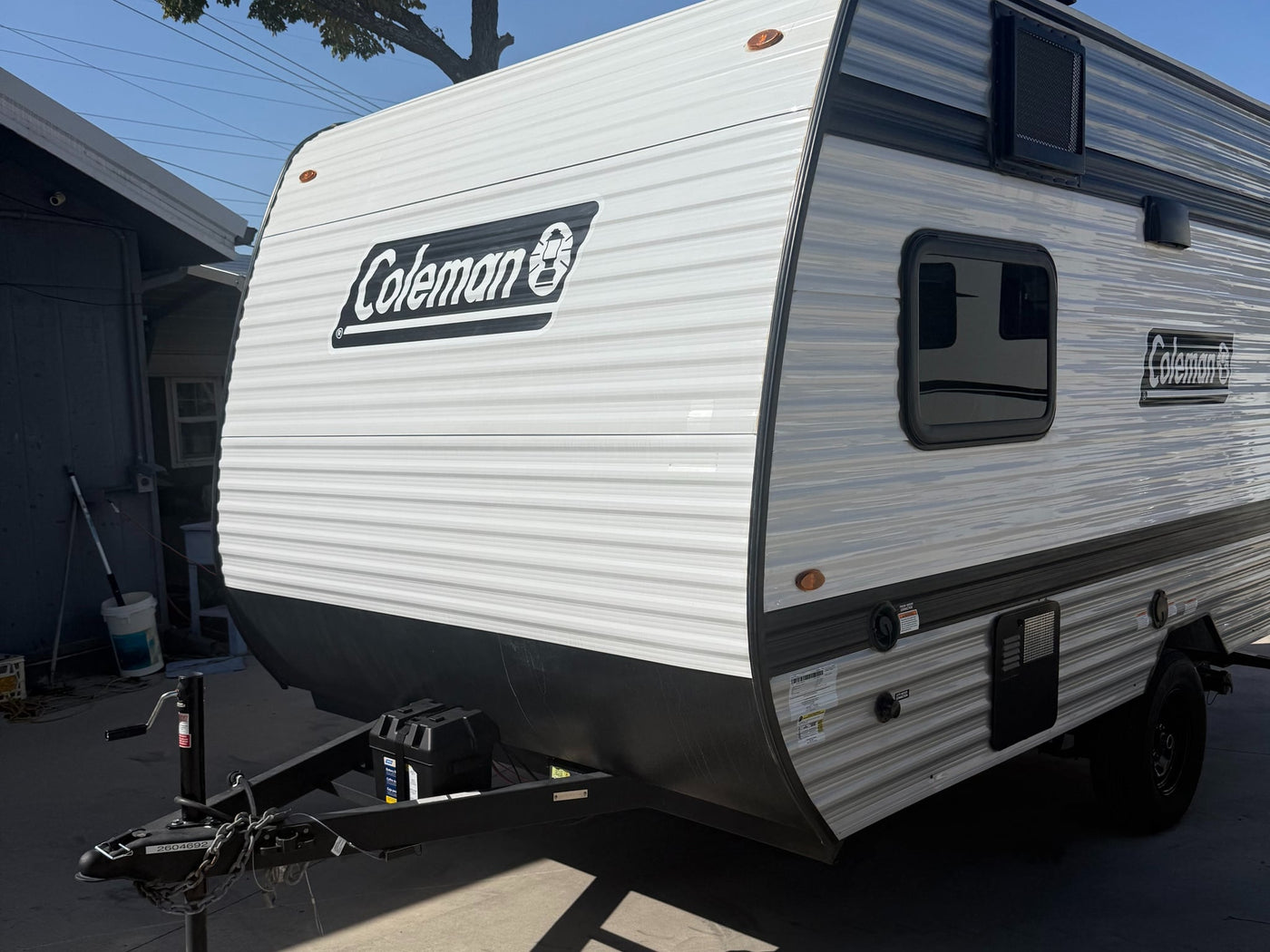 and cooktop. AC unit above.|Compact RV rental interior: kitchen with microwave — photo 11