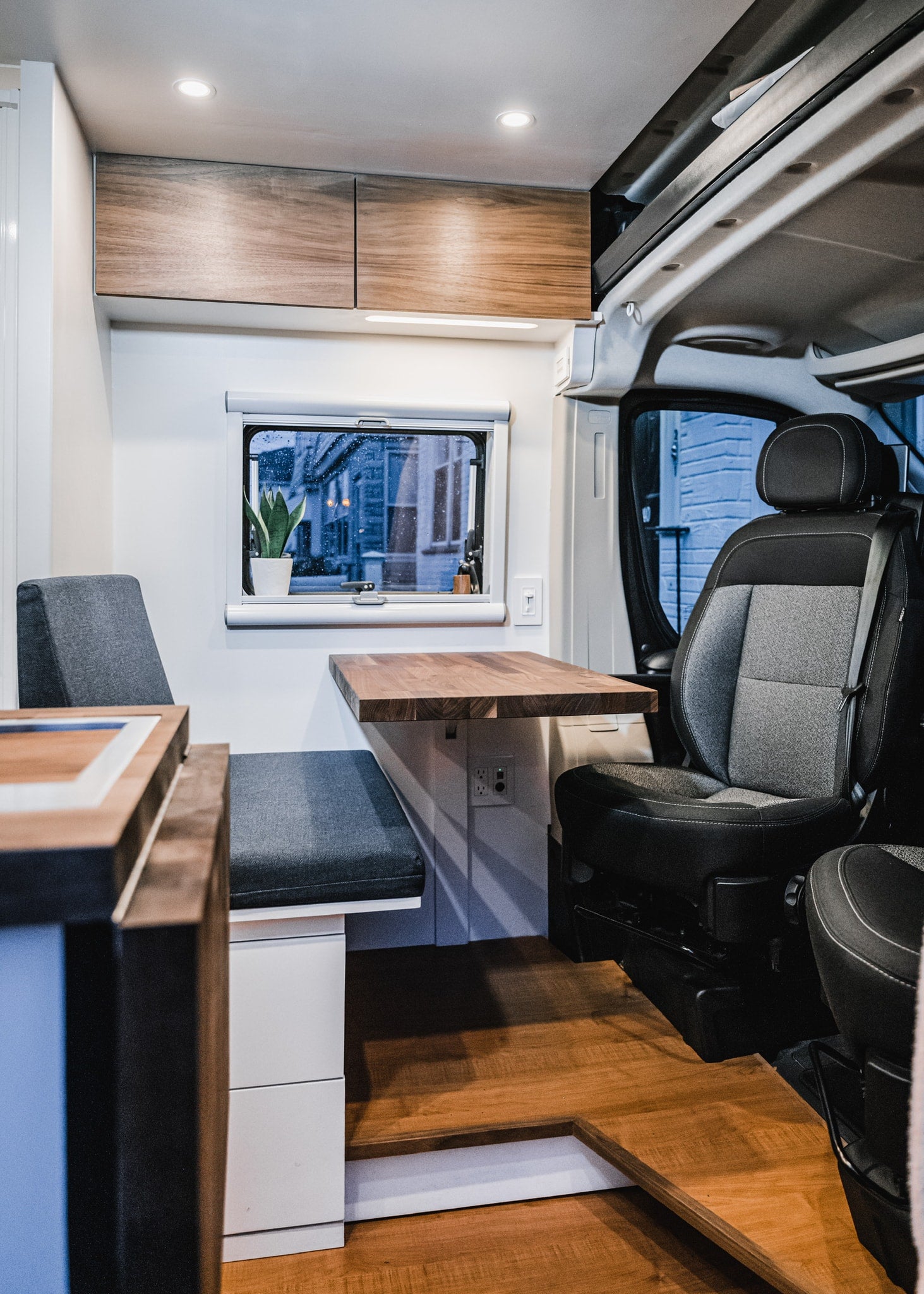 showcasing efficient design.|Cozy RV rental interior featuring a cute bear statue on a wooden table. Perfect for your next adventure!|Your next RV rental awaits! This camper van offers a bed
